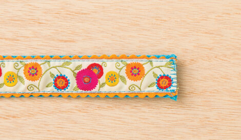 floral fabric with rickrack on the sides with zig zag pattern sewn on the end